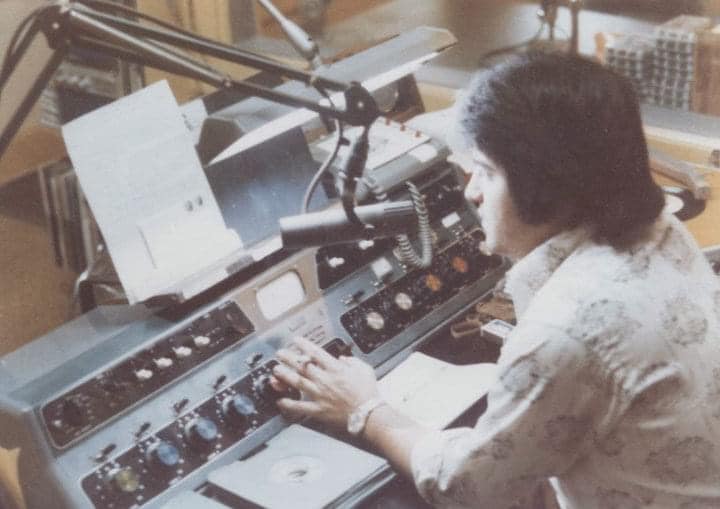 Broadcaster working at the studio control board