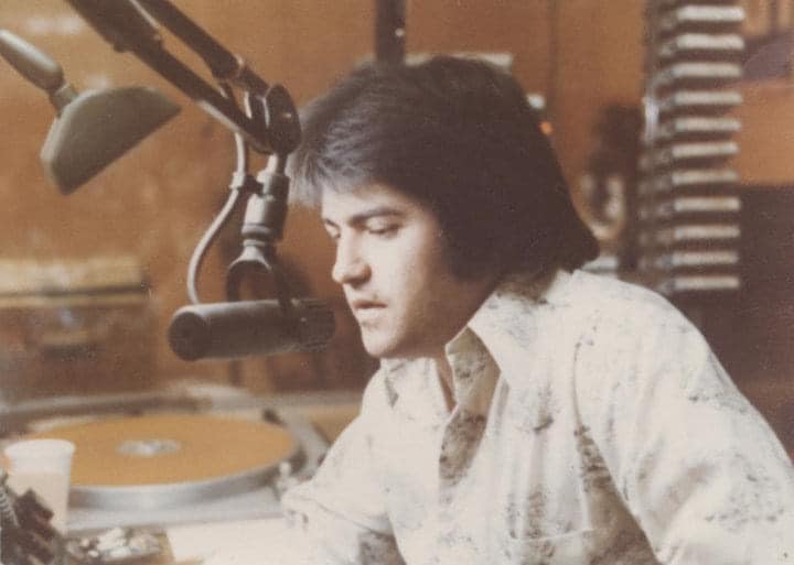 Broadcaster speaking into a studio microphone