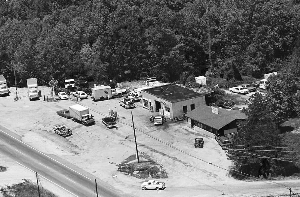 Aerial view of an automotive service yard with tow trucks and service buildings